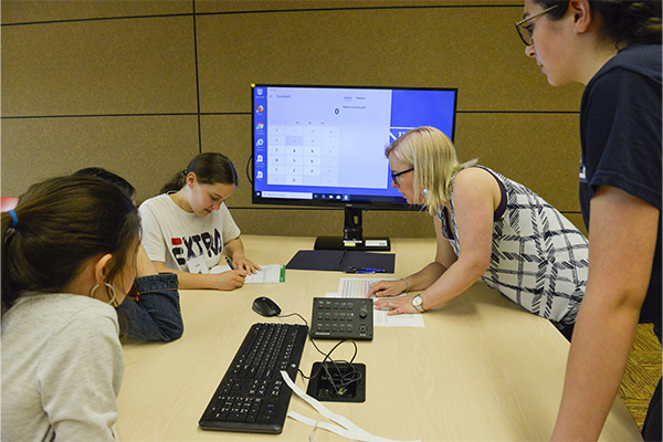 A young STEM student working on a robot